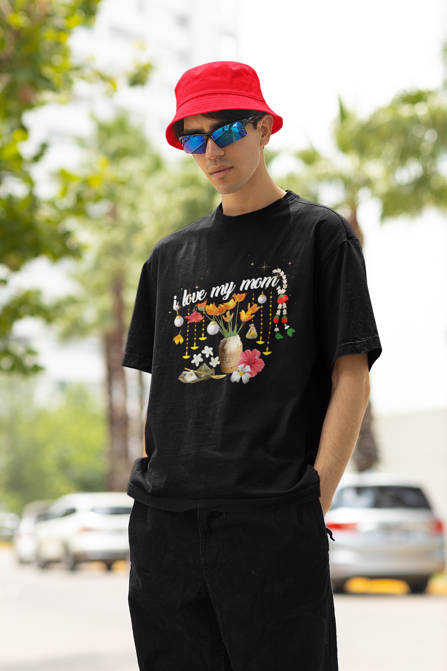 A man wearing "Limited Edition "I Love My Mom" (Style-03) Oversized Tee" unisex black t-shirt at front view - Unique fashion tops - Thai culture inspired, exotic design, standout, chic and cool. Perfect for everyday casual, summer and Mother's day. Front and back printed - Oh Mine Words