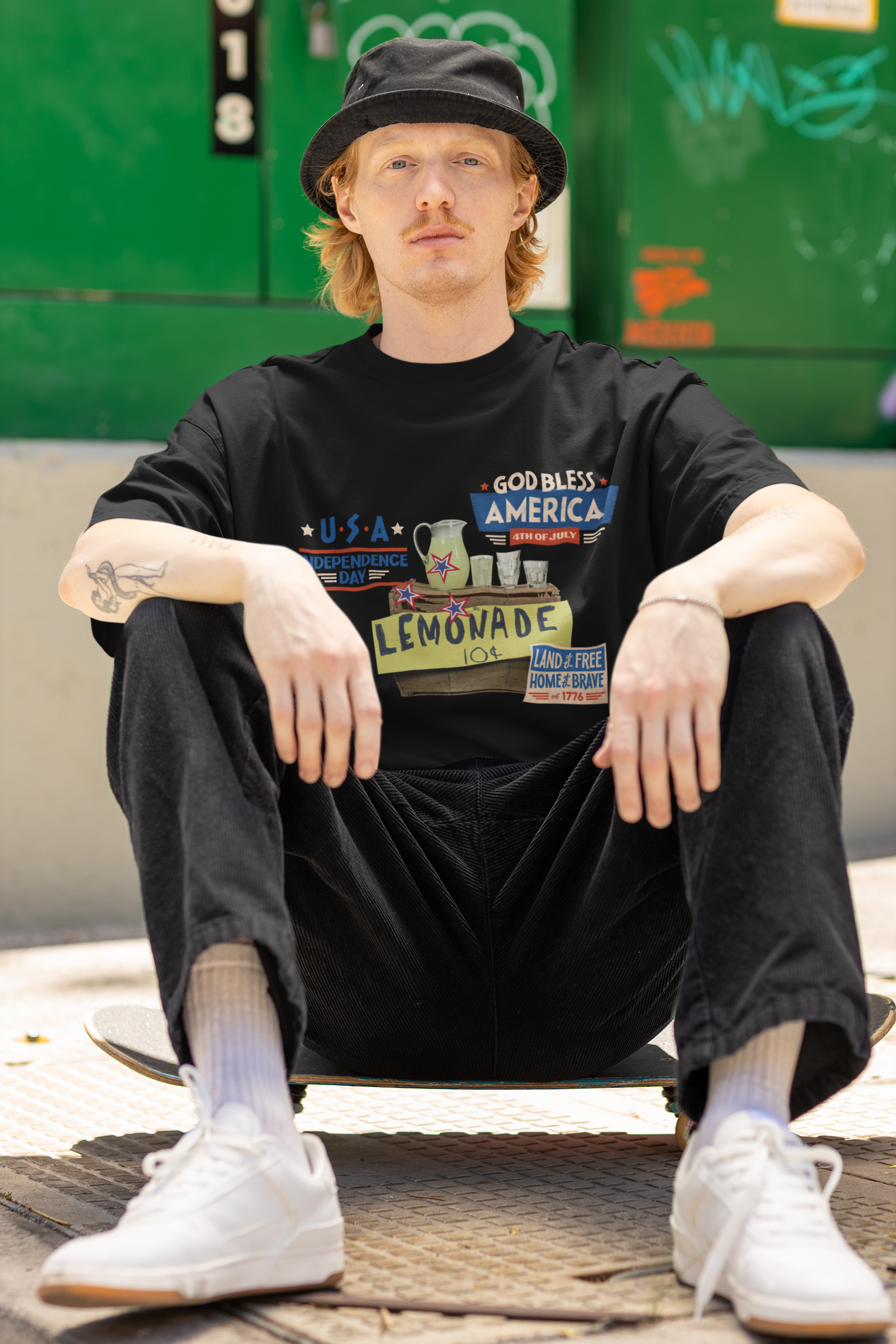 A man wearing Unisex Oversized The Lemonade T-shirt for 4th of July at front view – Unique Fashion Tops – Cool, Comfortable, Standout Black Streetwear with Front and Back Print – Oh Mine Words