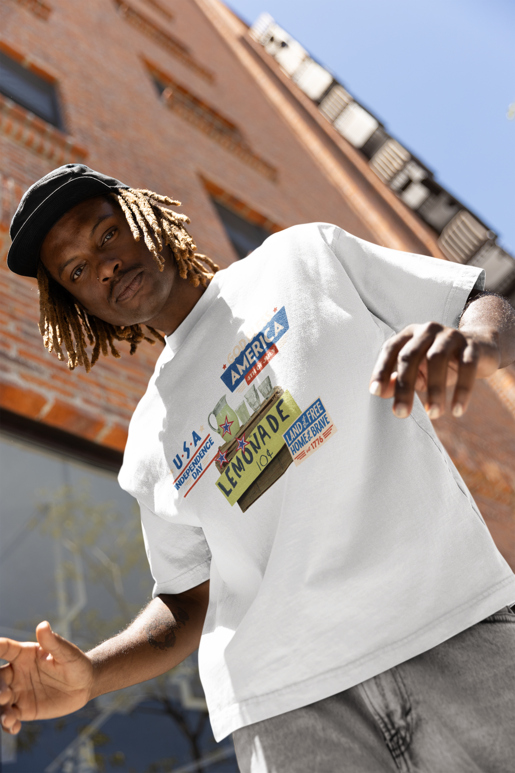 A man wearing Unisex Oversized The Lemonade T-shirt for 4th of July at front view – Unique Fashion Tops – Cool, Comfortable, Standout White Streetwear with Front and Back Print – Oh Mine Words
