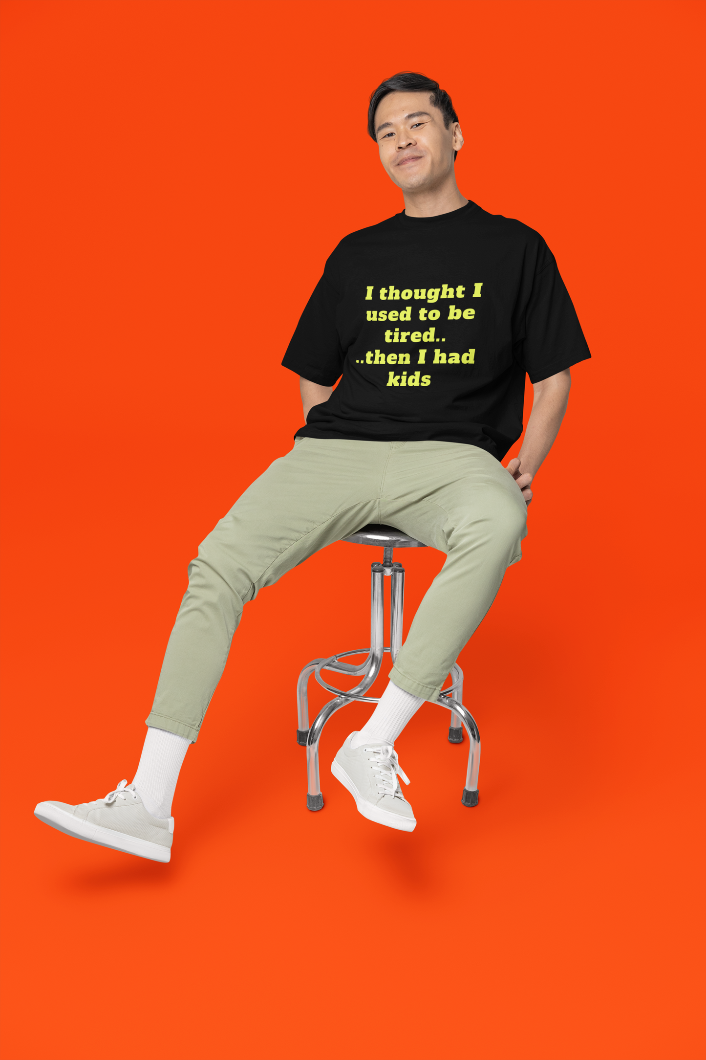 A man wearing unisex oversized "I Thought I Used To Be Tired (Black)" t-shirt at front view - unique fashion tops, funny quote for Adulthood, Parents, Parenthood, Dad, Mom - Front and Back Print - Oh Mine Words.