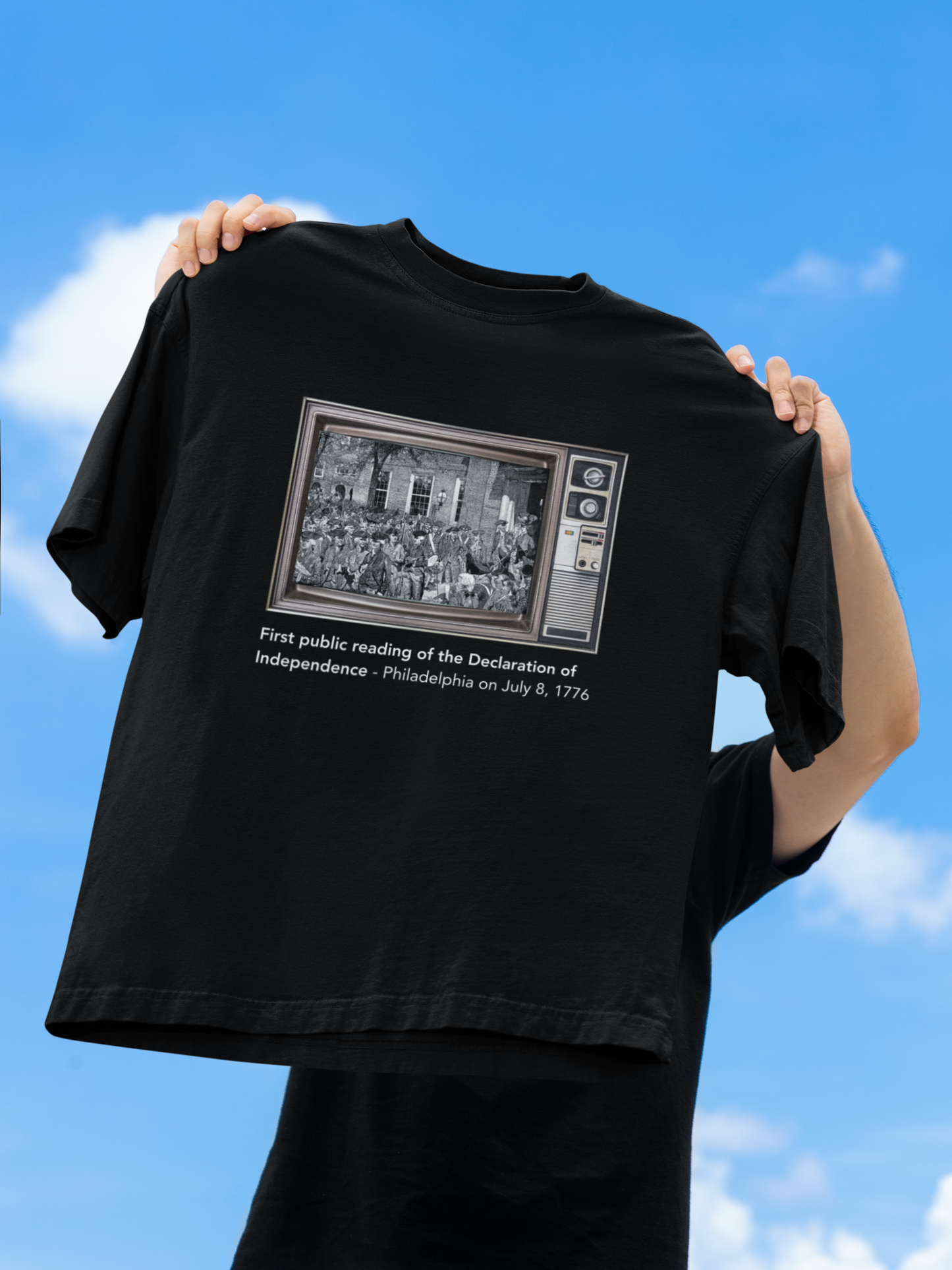 A person showing Unisex Oversized "First Public Reading of the Declaration of Independence" Black T-shirt at front view - Unique Fashion Tops - Front and Back Print - Oh Mine Words.