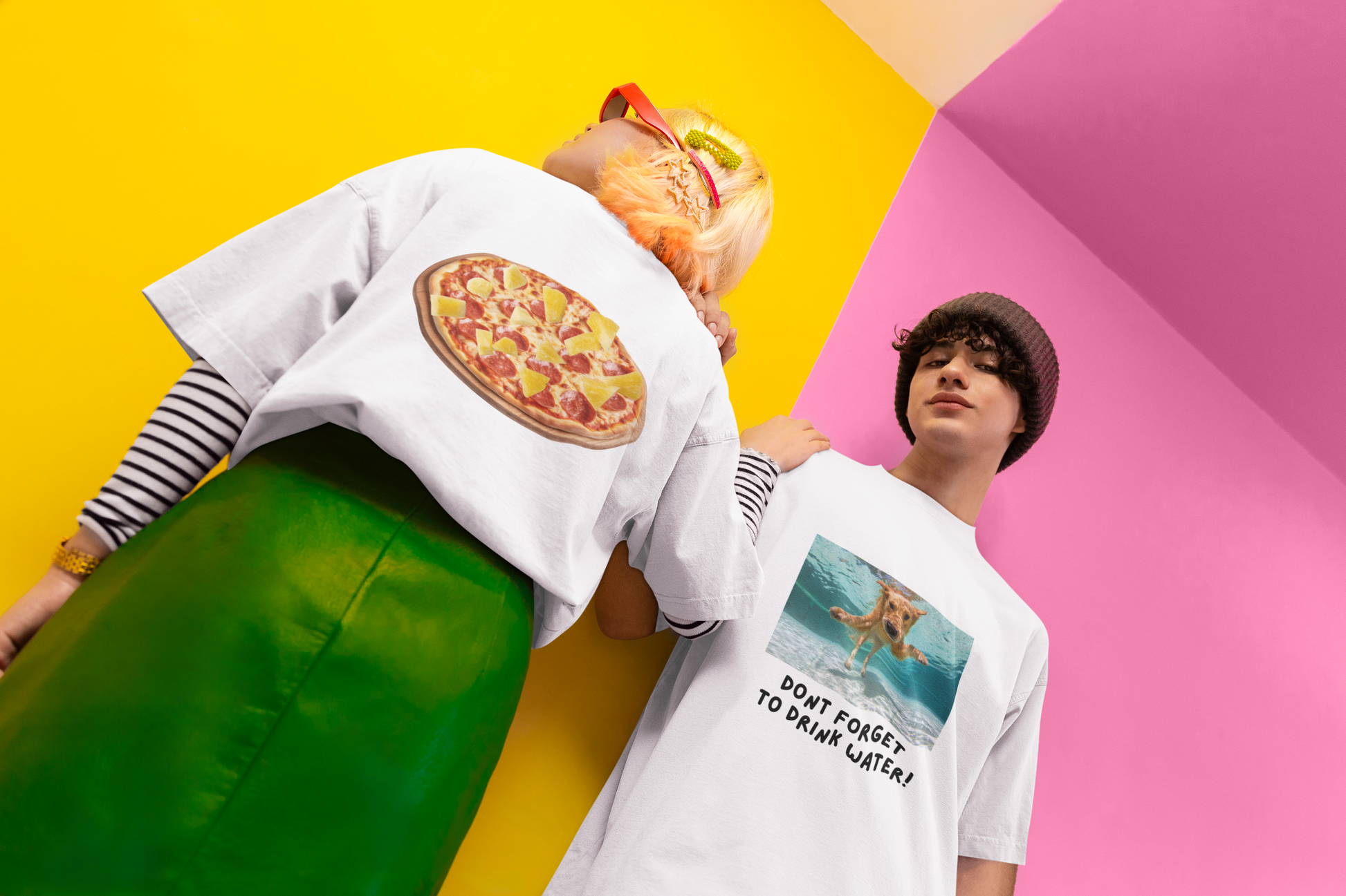 A women wearing "Not Suitable for Italian" T-shirt style-01 at back view, A man wearing "Don't Forget To Drink Water!" at front view - unisex oversized white t-shirt. Unique fashion tops. Funny quote - chill, casual, foodie, pizza, pineapple, dog lover. Front and back printed - Oh Mine Words