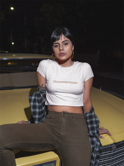 A women wearing white "I Love My Mom Baby Tee (Basic)"/ crop top/ slim fit tee at front view - Unique fashion tops for casual wear and Mother's day - Minimal Y2k style - Front and Back printed T-shirt - Oh Mine Words