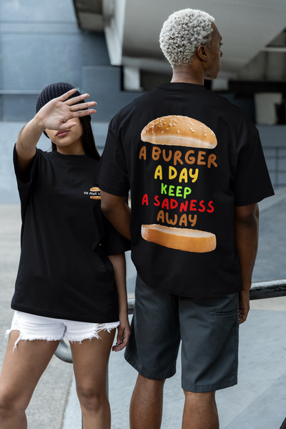 Women and men wearing unisex oversized "A Burger A Day Keep A Sadness Away" black t-shirt - unique fashion tops - funny quote, buns, burger, foodie, comfortable, front and back print - Oh Mine Words.